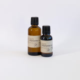 Two bottles of organic chamomile oil on a white background
