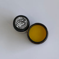 open jar of Goldenseal and Coptis balm with lids from above
