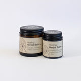 Two jars of Healing Herbal Balm on a white background