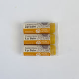 Three tubes of Calendula Lip Balm from House of Herbs on a white background