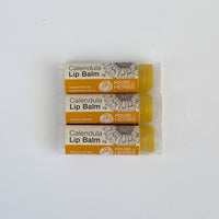 Three tubes of Calendula Lip Balm from House of Herbs on a white background