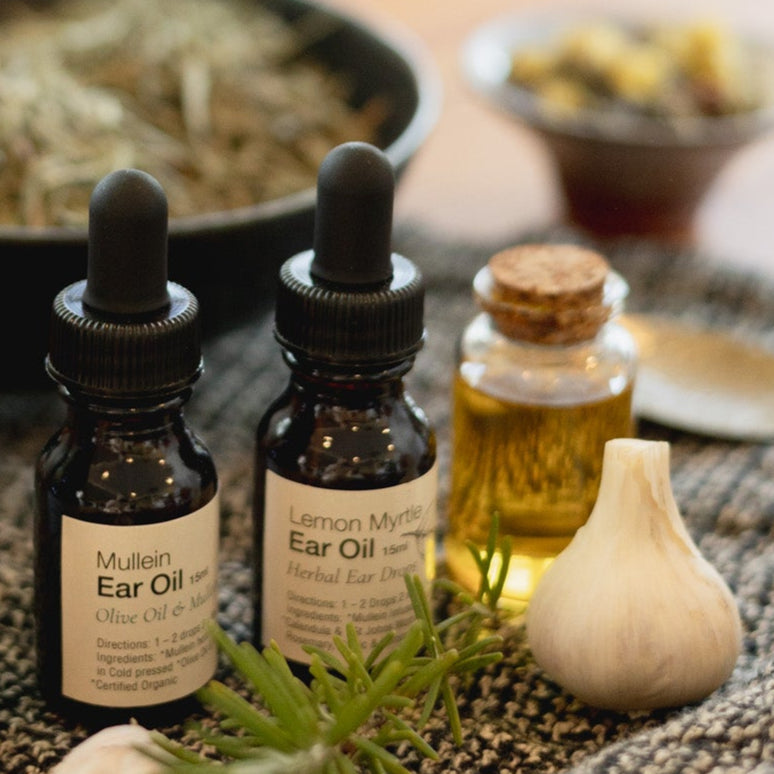 Herbal remedies with bottles of essential oils on a textured surface