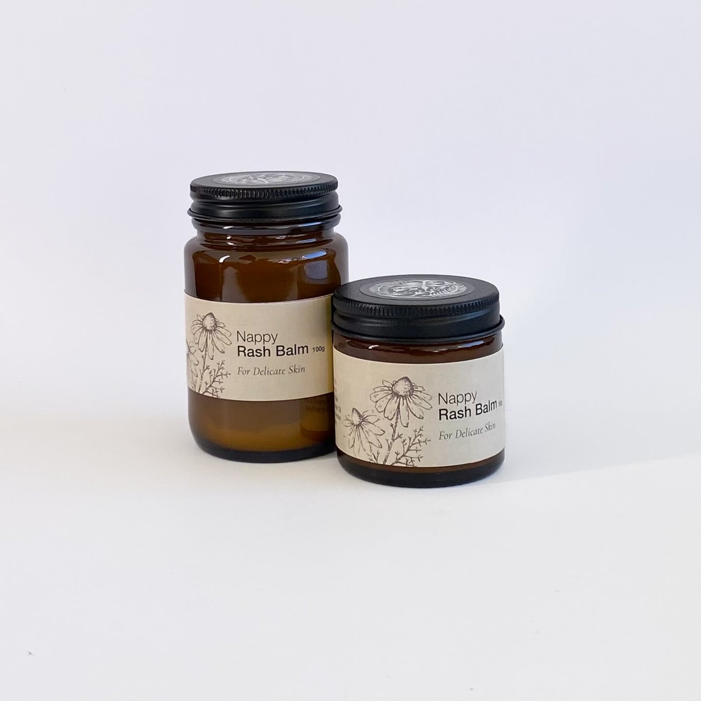 Two jars of Nappy Rash Balm for sensitive babies skin on a white background